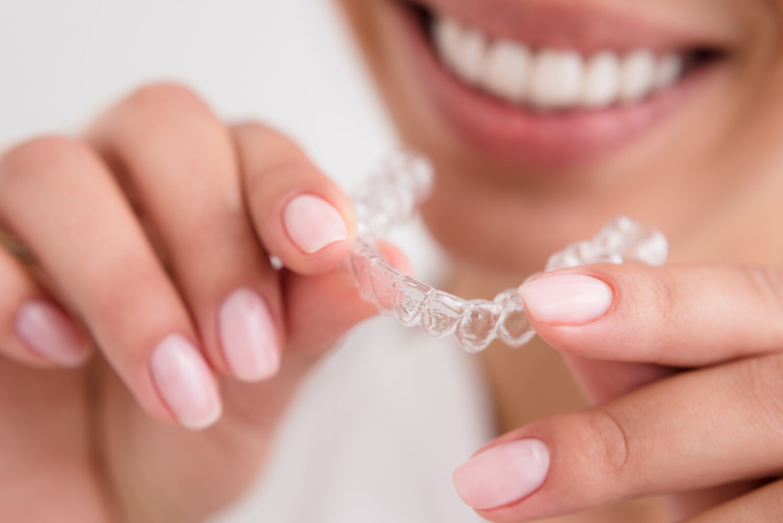 woman beautiful smile holding a transparent mouth guard