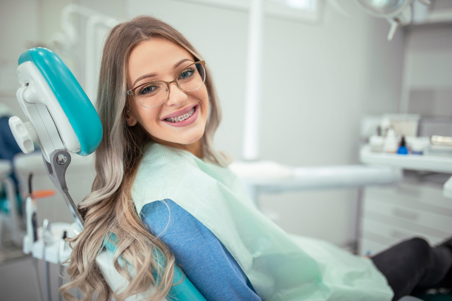 Smiling Teen In Orthodontist Chair Wearing Braces